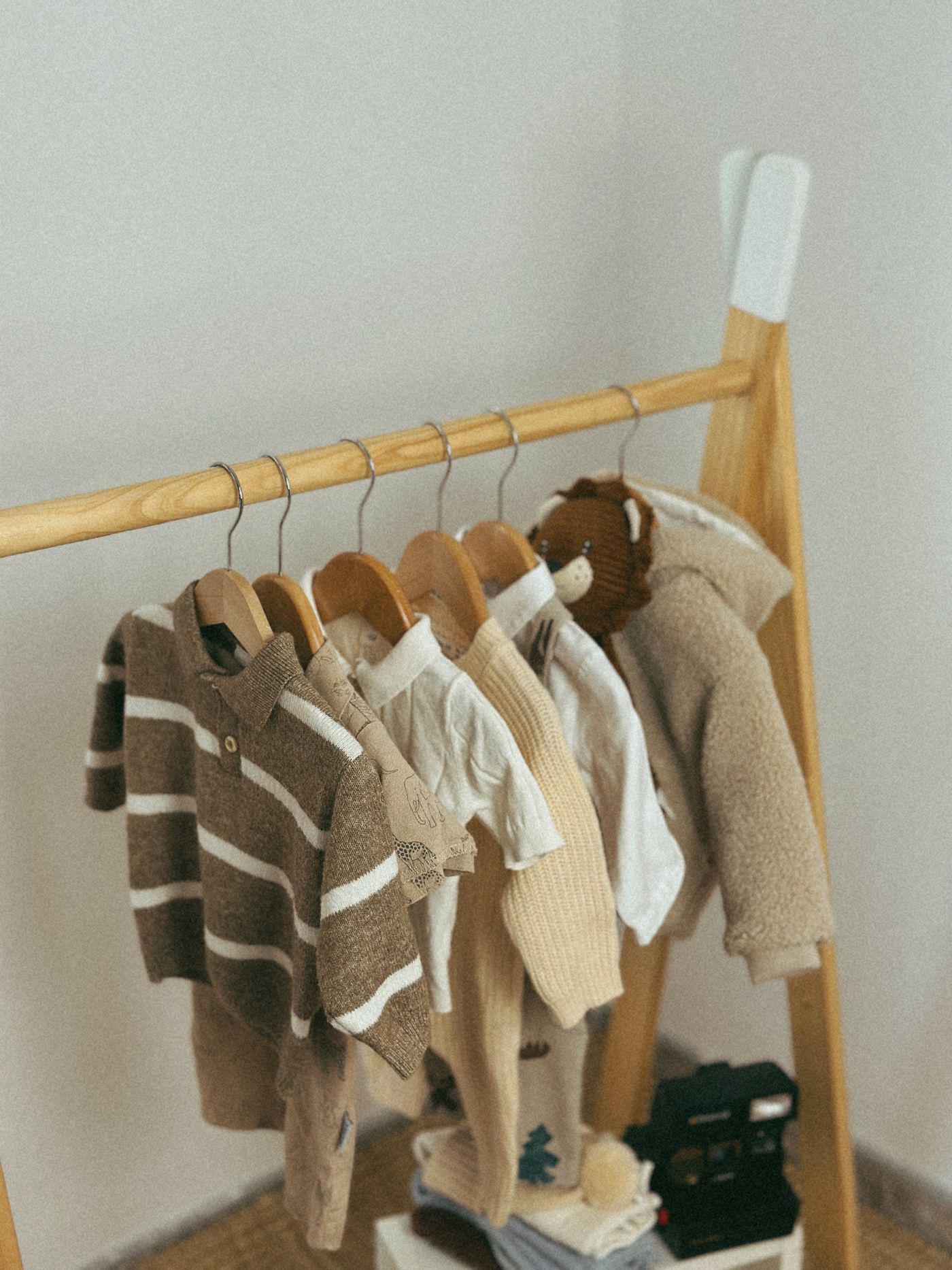 Children's knitted clothing on a wooden rail