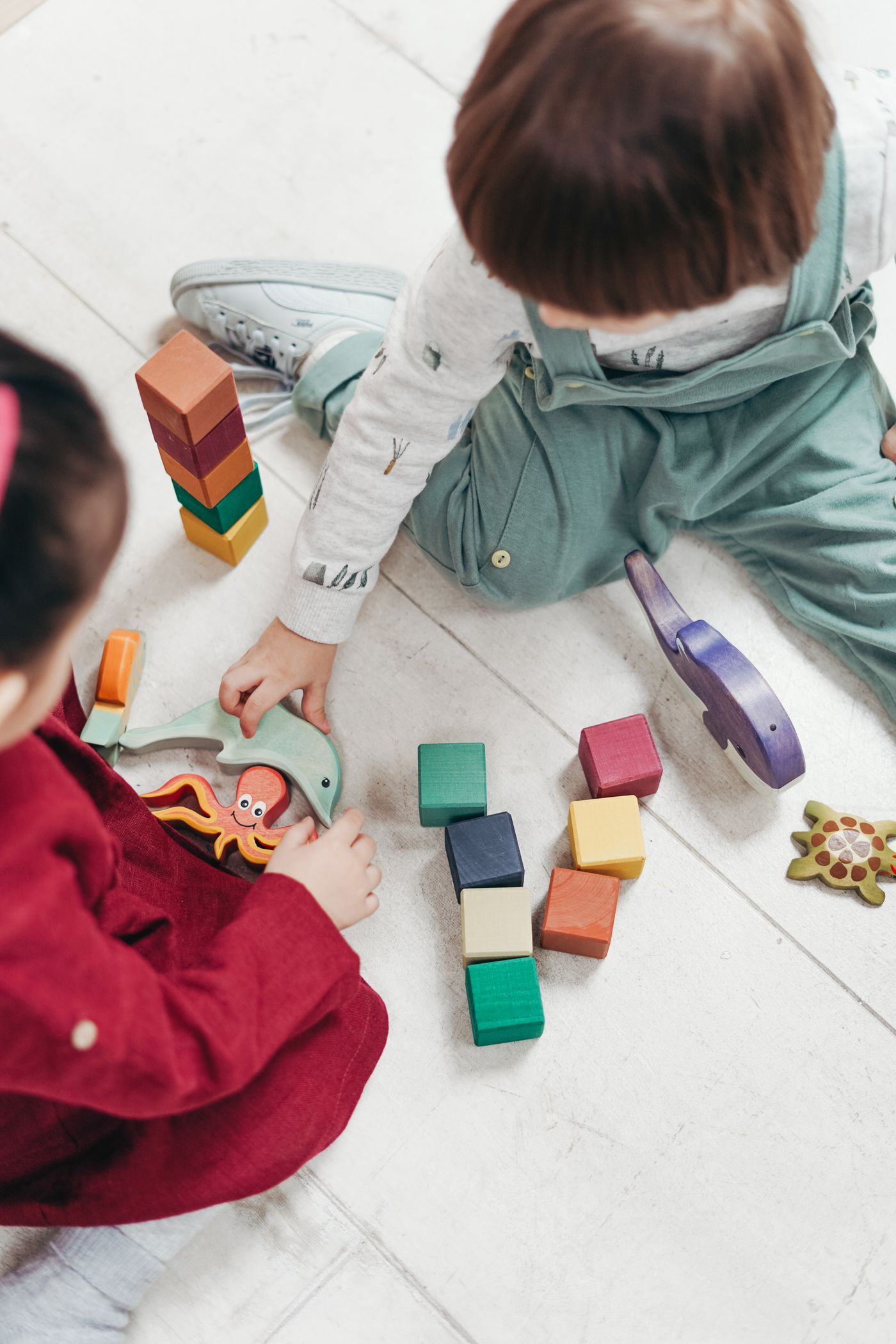 Child playing with coloured wooden blocks