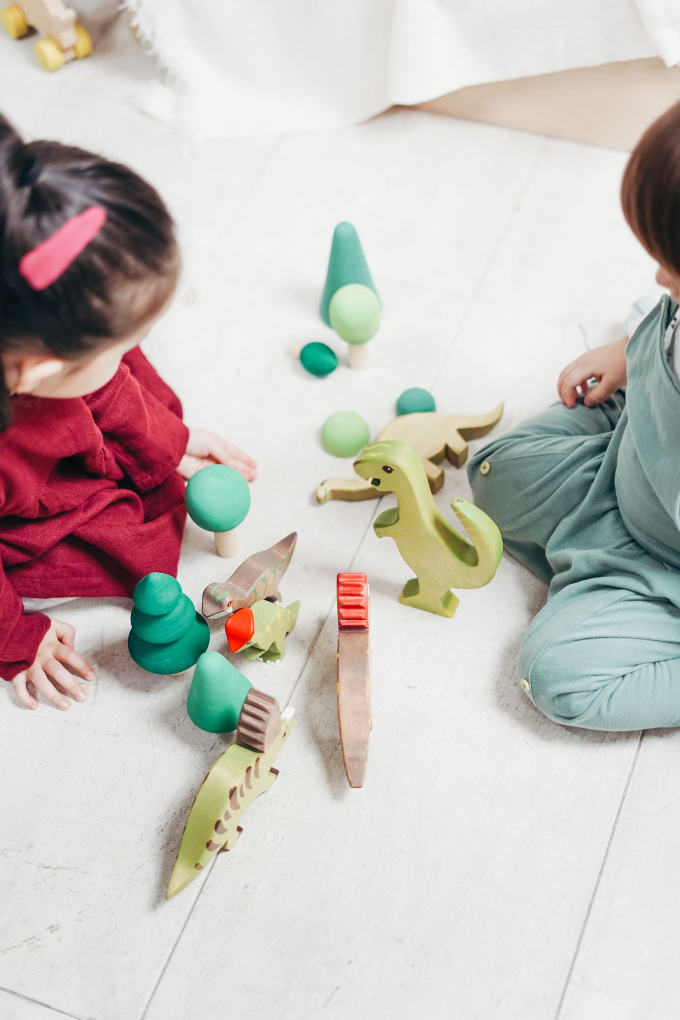 Wooden animal figures and blocks on a floor mat